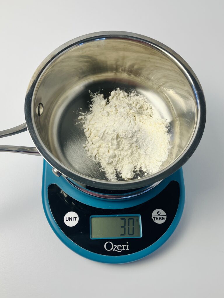 saucepan on scale with flour