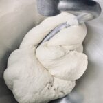 firm dough being kneaded in a stand mixer